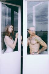 Couple Standing by the Window