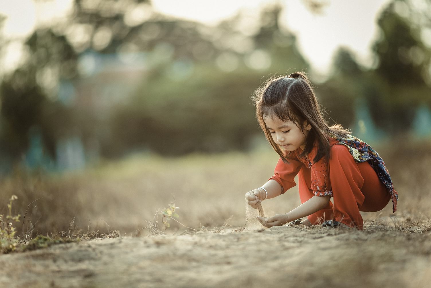 Little Asian Girl Playing with Sand