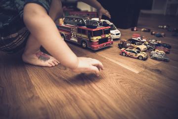 Boy Playing with His Cars