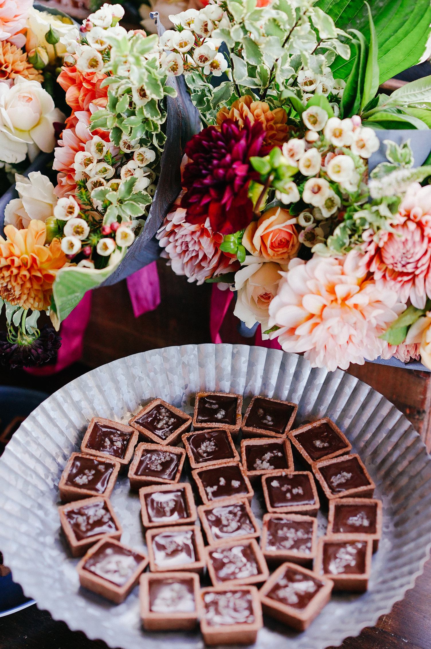 Bouquet of Flowers and Chocolates on the Table