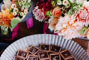 Bouquet of Flowers and Chocolates on the Table