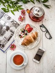 Breakfast Composition with Book, Croissant and Tea