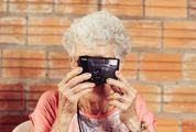 Old Lady Taking a Picture with Her Analog Camera