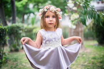 Cute Little Girl with Flower Wreath and Satin Dress