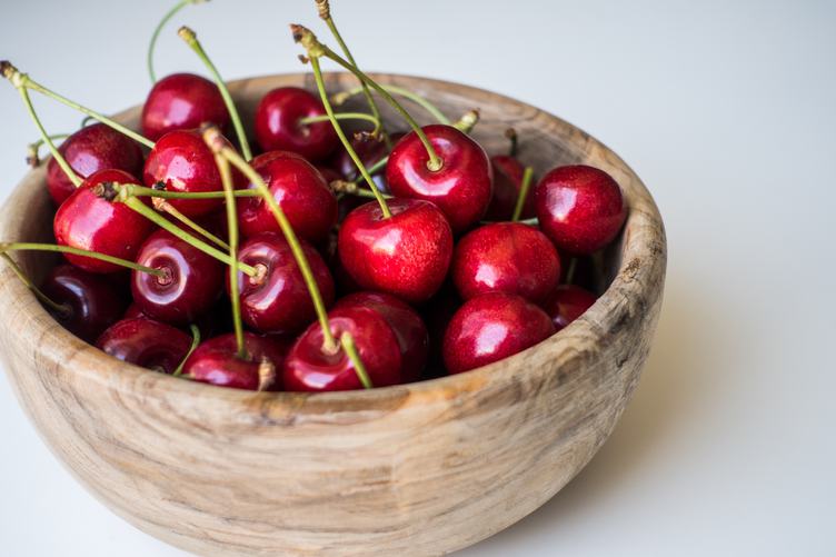 Wooden Bowl full of Fresh Cherries