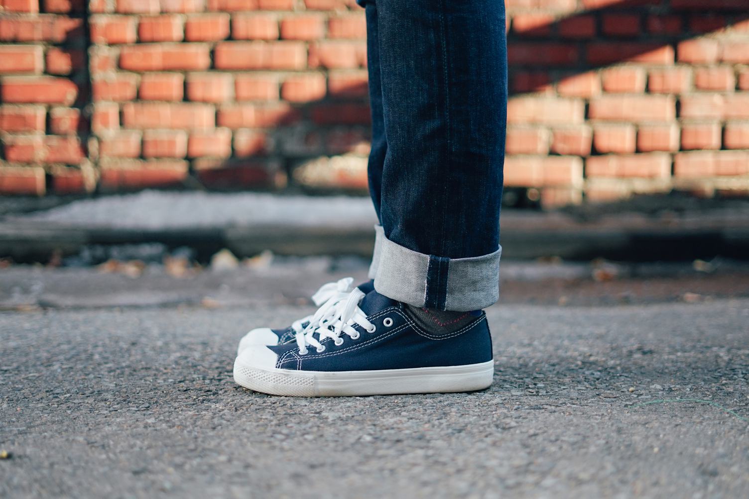 Standing in Sneakers and Jeans on the Street