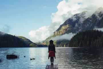 Young Woman Stands on a Wooden Pier, Buntzen Lake, Canada