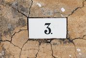 Number Three Sign on Old Cracked Wall