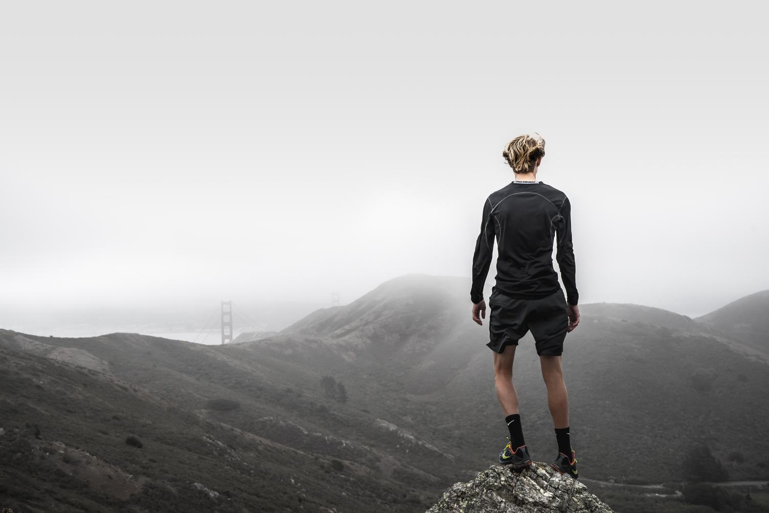 Runner Standing on Top of a Hill and Enjoying View