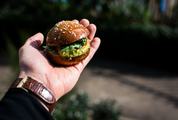 Man Holding a Mini Burger