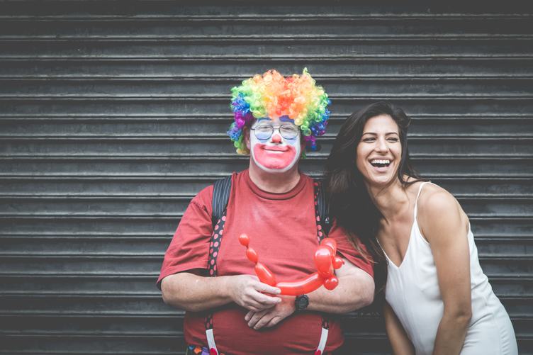 Man Dressed up as a Clown with a Laughing Woman