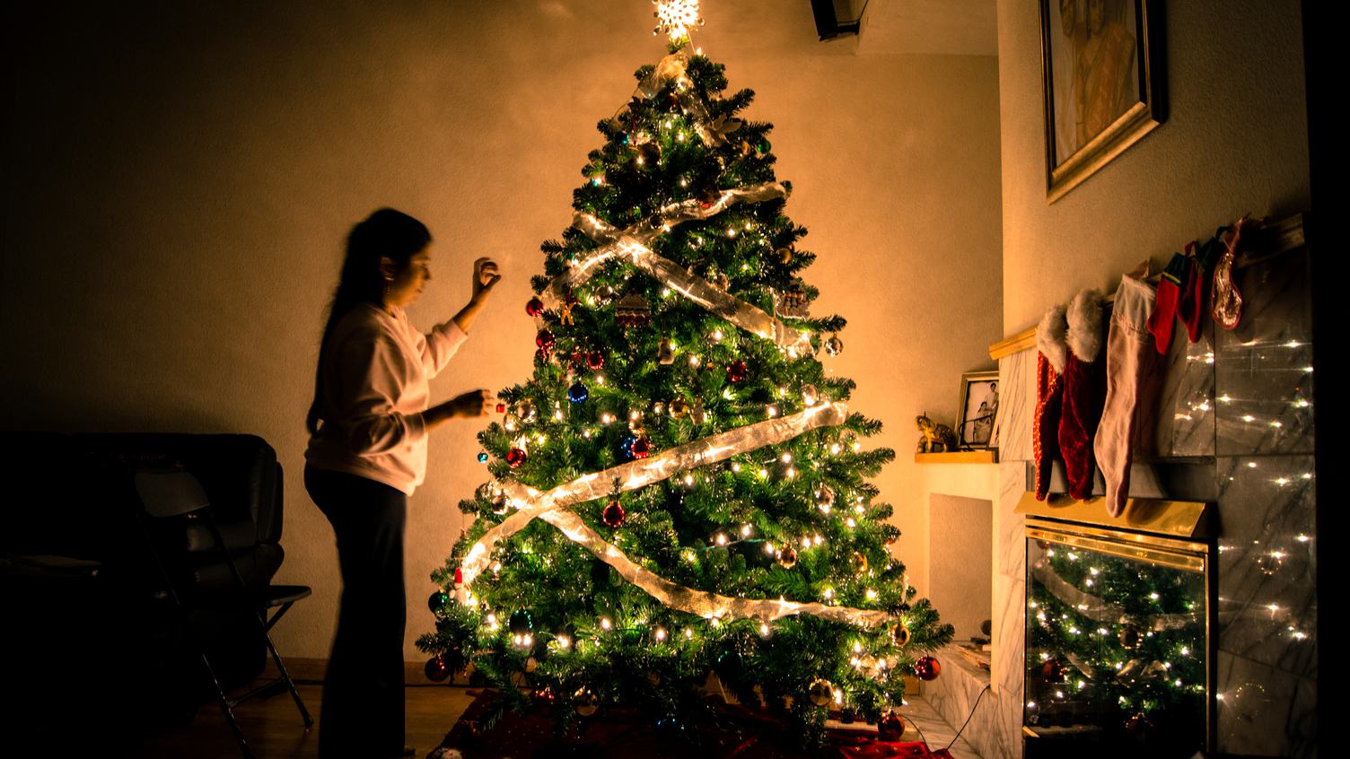 Woman Decorating Christmas Tree