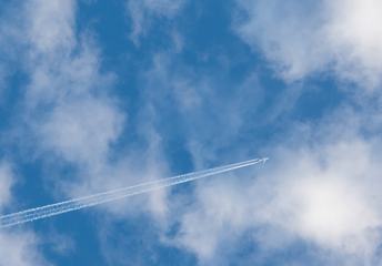 Plane Flying against Cloudy Sky