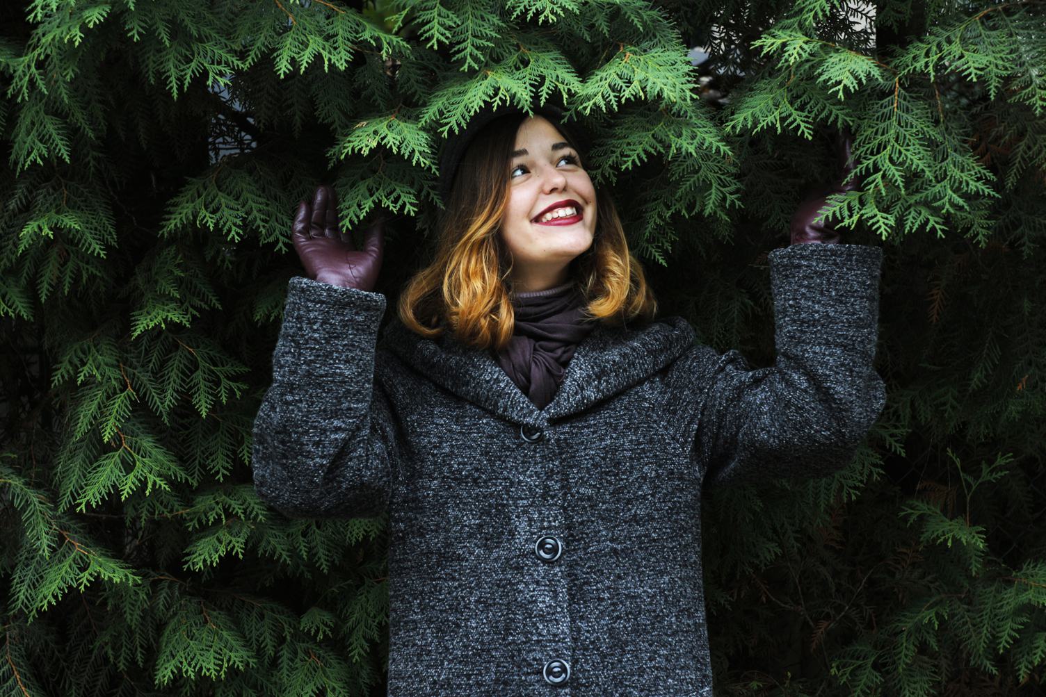 Laughing, Young Woman in a Gray Coat