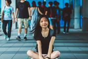 Girl Sitting on the Sidewalk