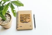 Top View Image of Notebook, Pen and Plant