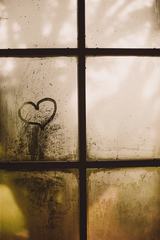 A Heart Painted on a Misted Window