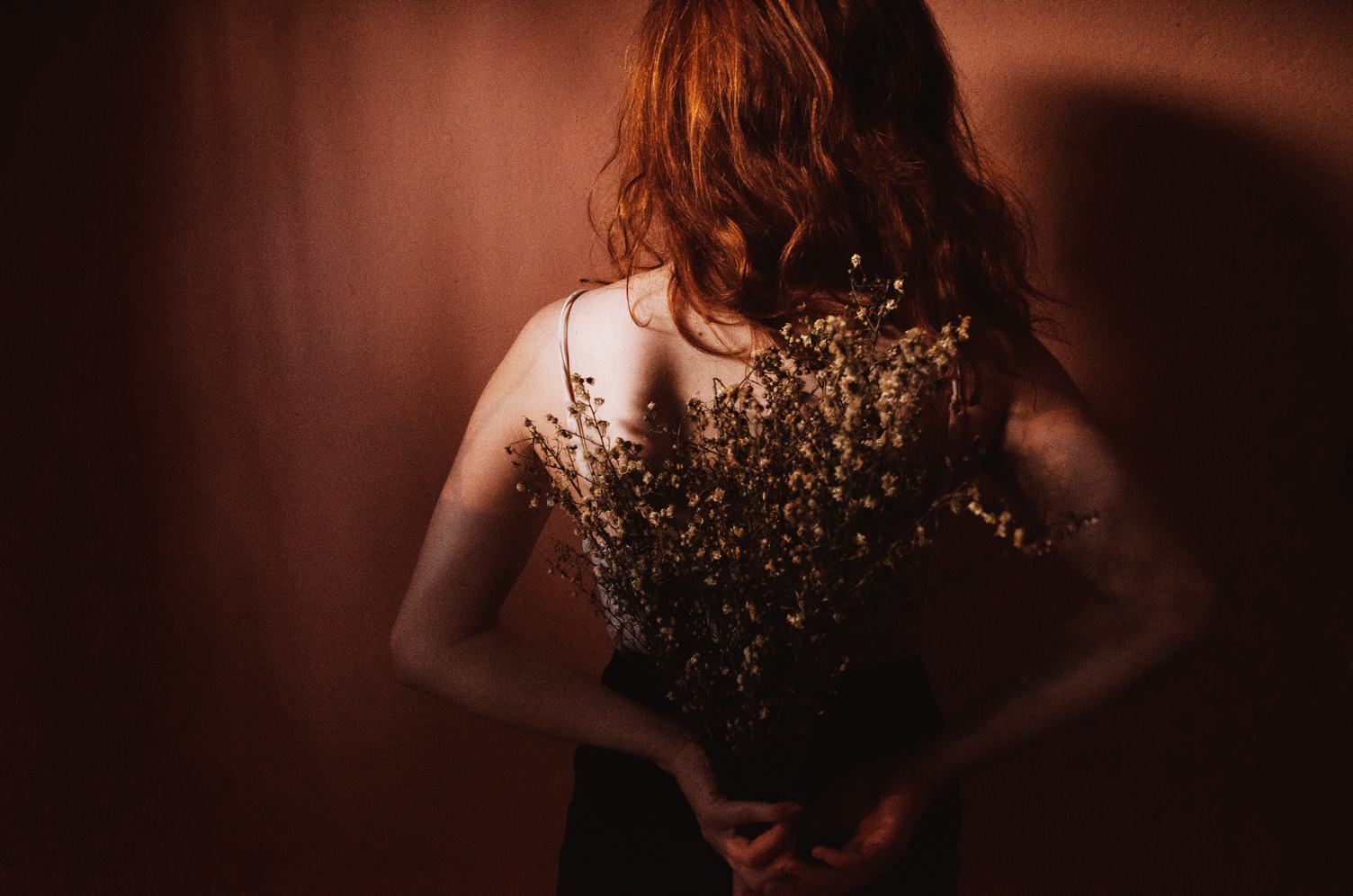 Red Hair Woman Standing Back with Dried Flowers