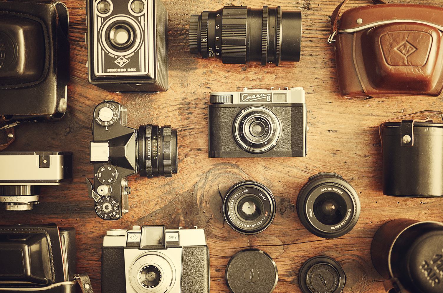 Retro Cameras and Lenses on the Wooden Table, Flat Lay