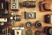 Retro Cameras and Lenses on the Wooden Table, Flat Lay