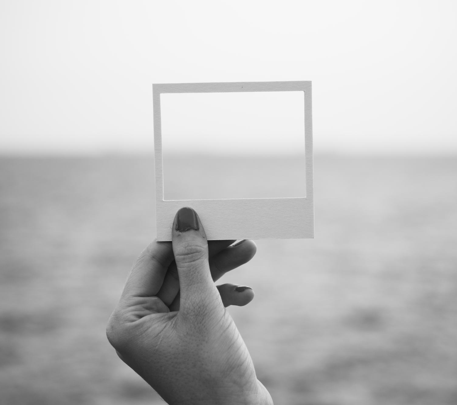 Female Hand Holding Empty Frame