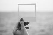 Female Hand Holding Empty Frame