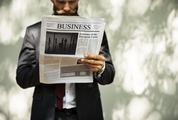 Businessman Holding a News Outdoors