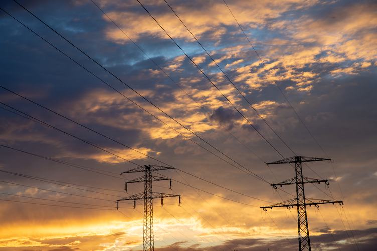 Golden Hour Sky with High Voltage Pylons