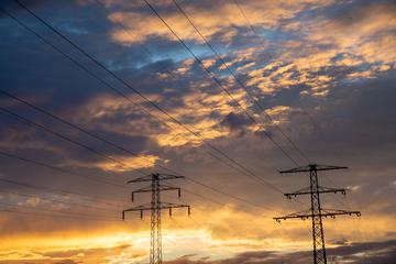 Golden Hour Sky with High Voltage Pylons
